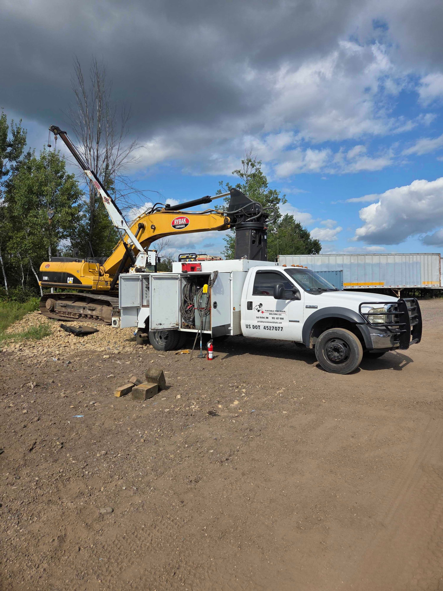 Mobile welding service truck on-site next to a CAT 336E excavator for heavy equipment repair